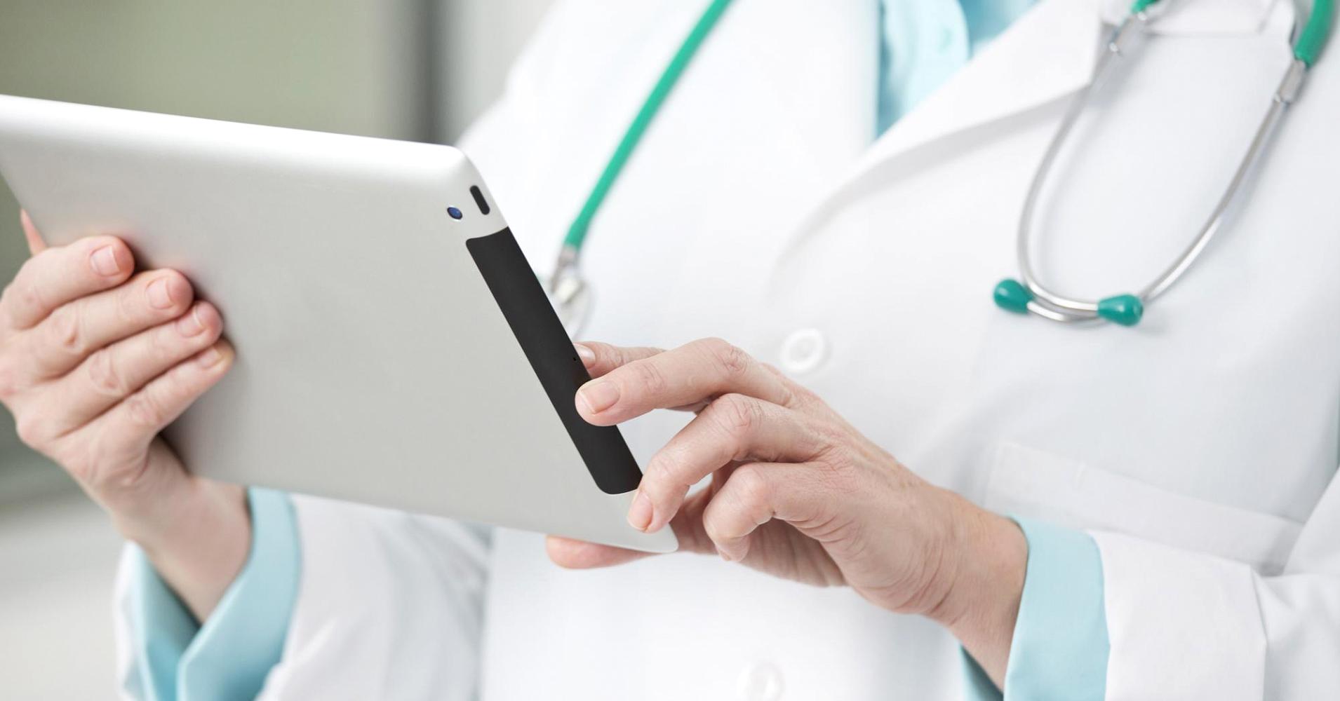 Image of a physician holding an iPad